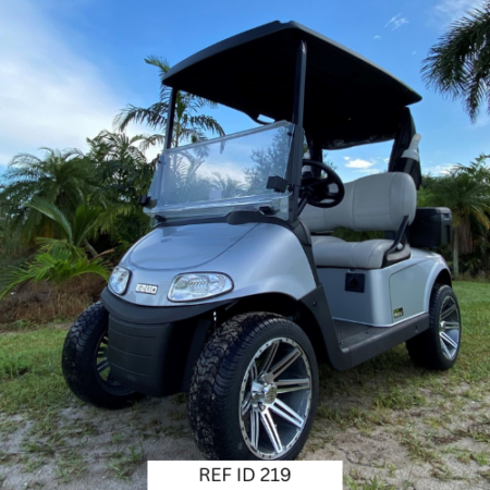 E-Z-GO RXV Elite Platinum golf cart with custom wheels, seats, windshield, and sand bottles